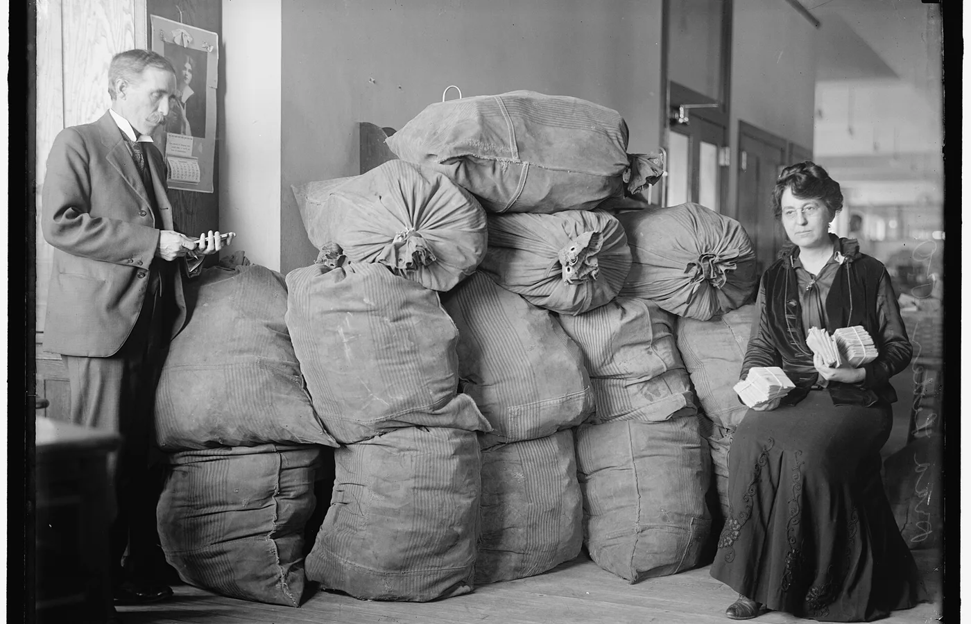 Dead Letter Mail superintendent Marvin McLean and clerk Clara R. A. Nelson at work