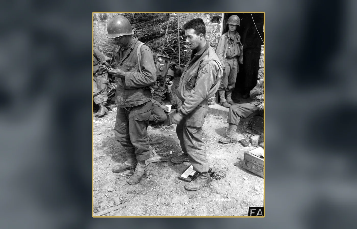 U.S. communications personnel examining a captured German radio in France in 1944; contextual evidence of the signals environment Ghost Army operators exploited