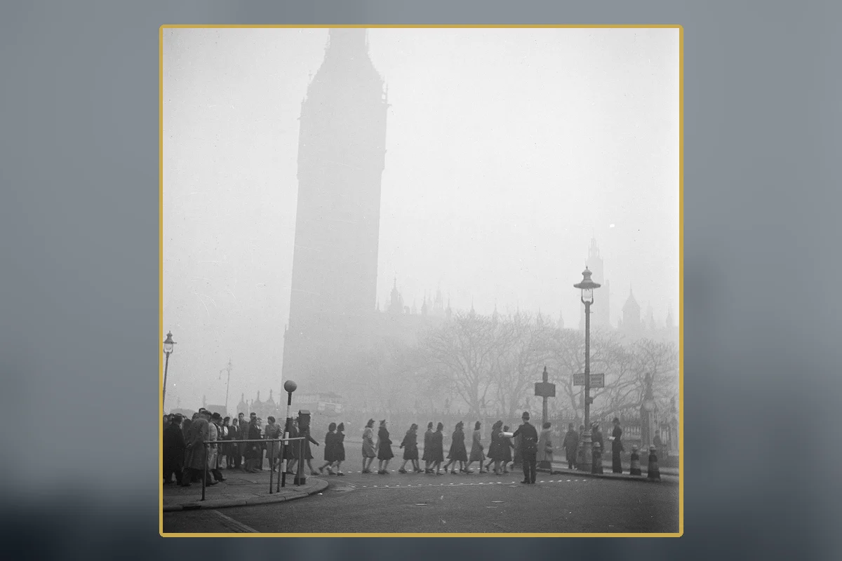 Pedestrians moving through dense London smog with Big Ben behind them